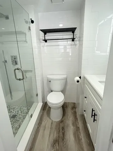 a bathroom with a toilet and a shower