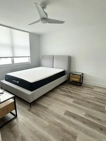 a bedroom with a bed and window