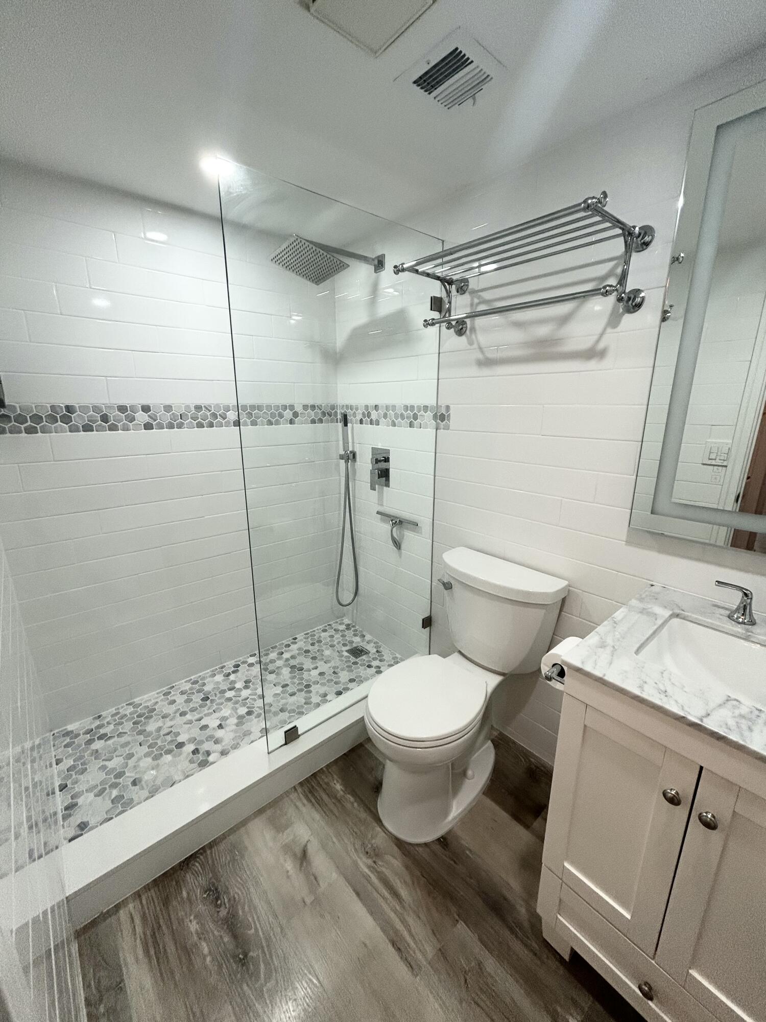 4511 South Ocean Boulevard, Unit 204 Highland Beach, FL 33487 - Photo 10 of 19 a bathroom with a granite countertop sink toilet and shower