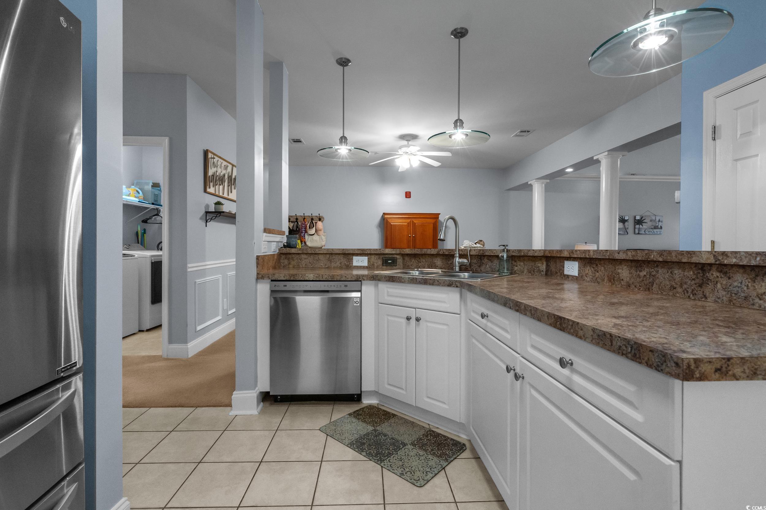 70 Addison Cottage Way, Unit 322 Murrells Inlet, SC 29576 - Photo 12 of 40 Kitchen with white cabinetry, stainless steel appliances, light tile patterned flooring, a ceiling fan, and dark countertops