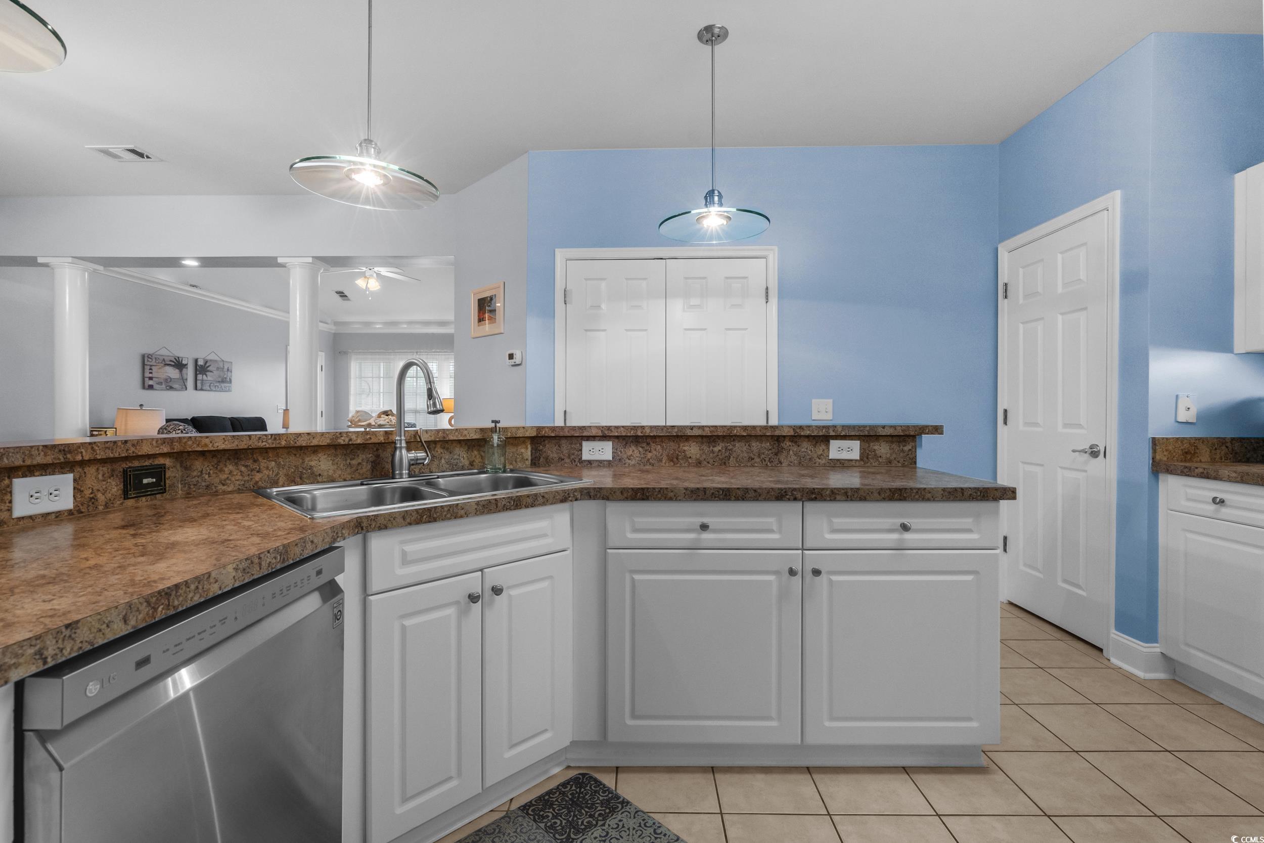 70 Addison Cottage Way, Unit 322 Murrells Inlet, SC 29576 - Photo 13 of 40 Kitchen with white cabinetry, dishwasher, dark countertops, light tile patterned floors, and hanging light fixtures