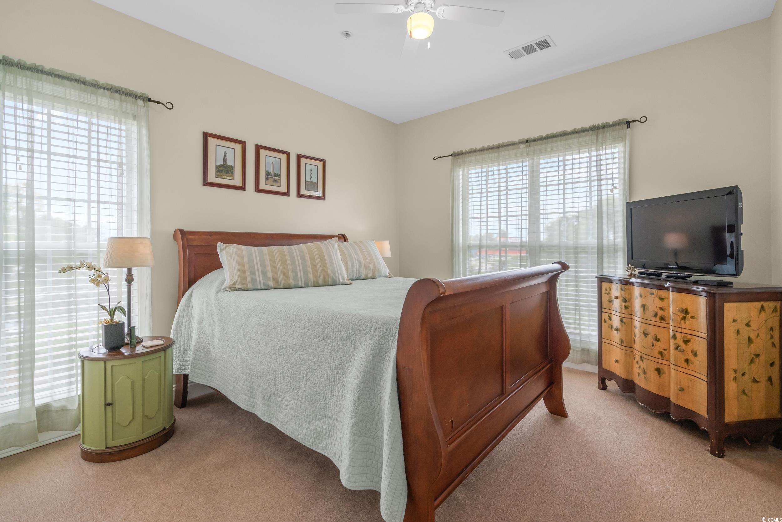 70 Addison Cottage Way, Unit 322 Murrells Inlet, SC 29576 - Photo 24 of 40 Bedroom with light carpet and ceiling fan