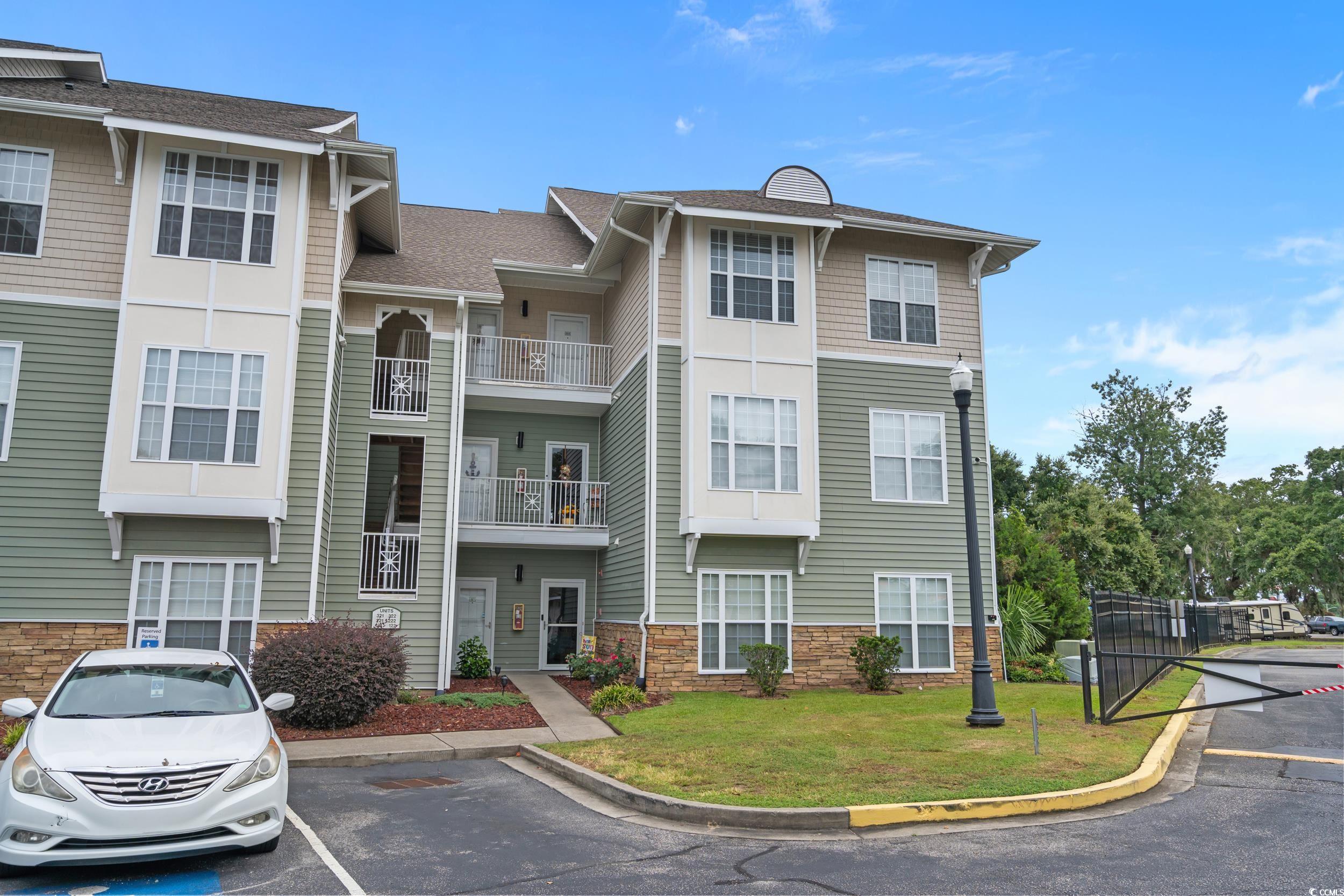 70 Addison Cottage Way, Unit 322 Murrells Inlet, SC 29576 - Photo 31 of 40 View of building exterior with uncovered parking