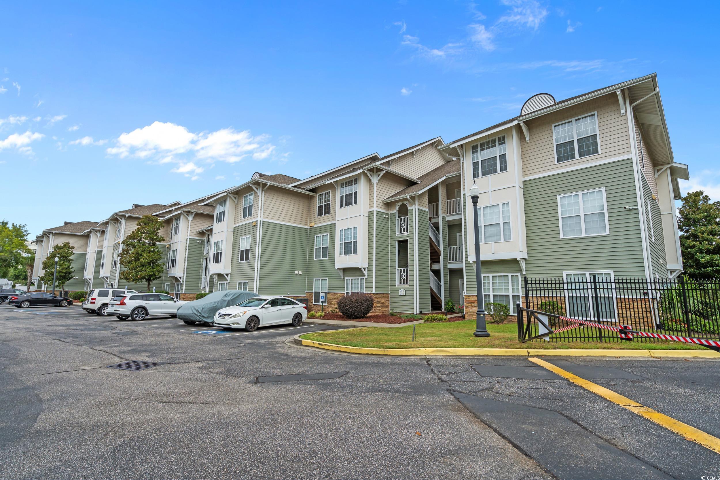 70 Addison Cottage Way, Unit 322 Murrells Inlet, SC 29576 - Photo 32 of 40 View of building exterior with uncovered parking and a residential view