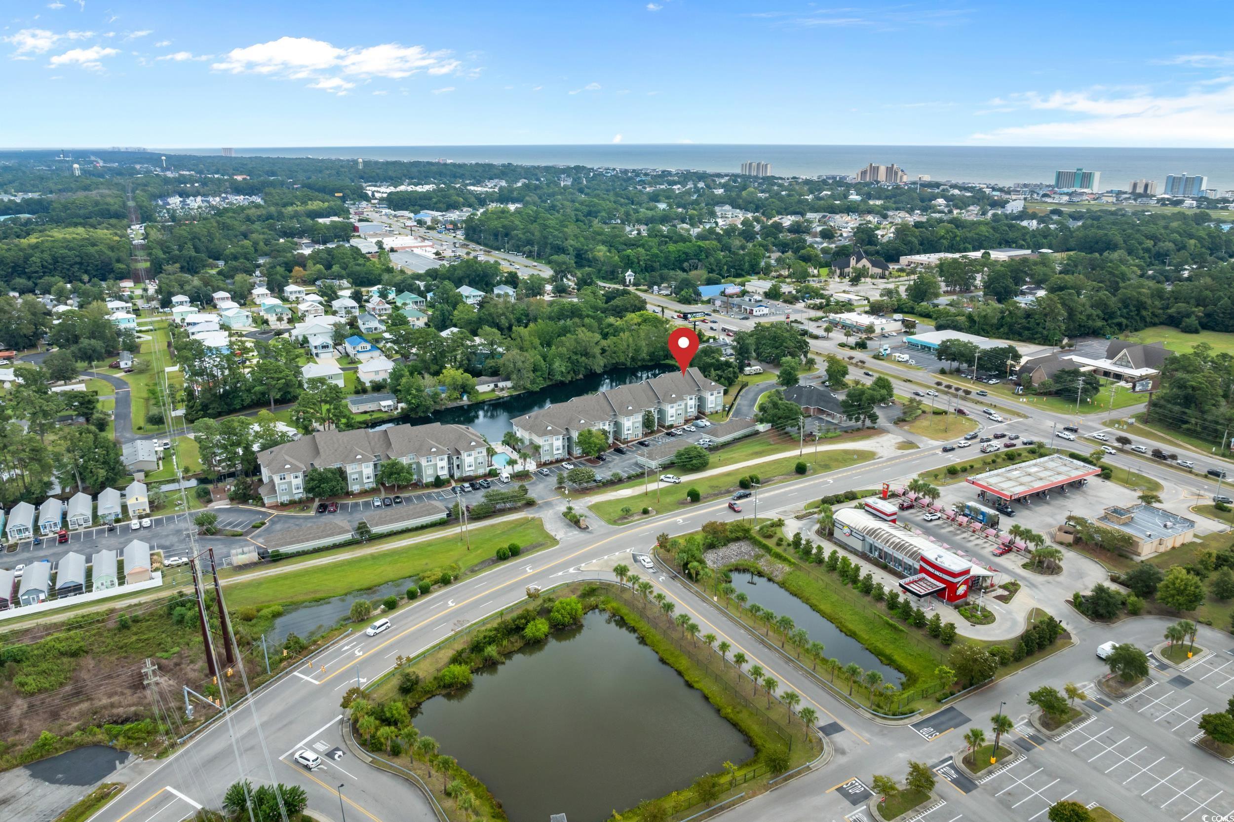 70 Addison Cottage Way, Unit 322 Murrells Inlet, SC 29576 - Photo 38 of 40 Drone / aerial view of a nearby body of water and a tree filled landscape