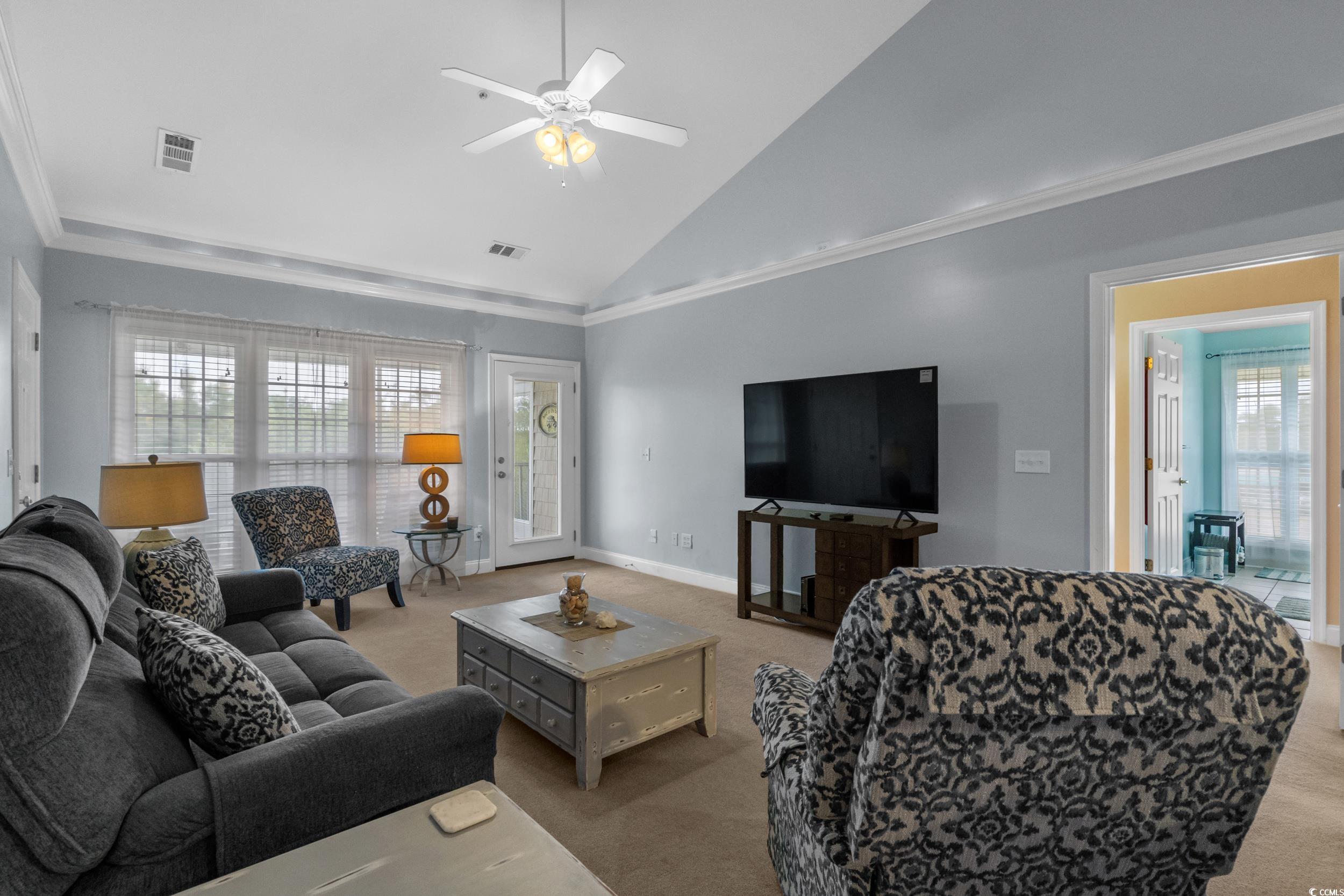 70 Addison Cottage Way, Unit 322 Murrells Inlet, SC 29576 - Photo 4 of 40 Carpeted living area with high vaulted ceiling, ornamental molding, and ceiling fan