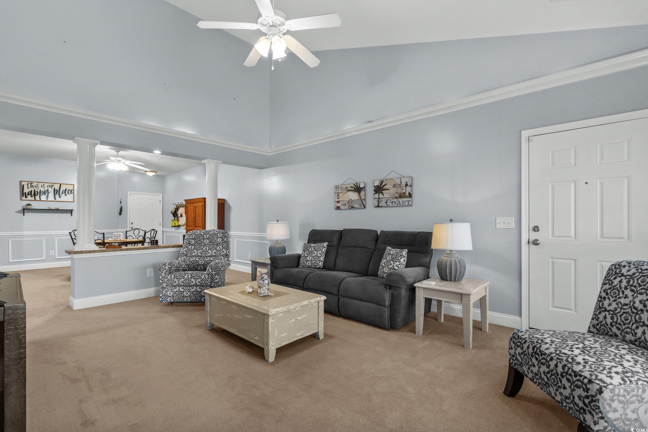 70 Addison Cottage Way, Unit 322 Murrells Inlet, SC 29576 - Photo 9 of 40 Carpeted living room with ceiling fan, ornate columns, high vaulted ceiling, and crown molding