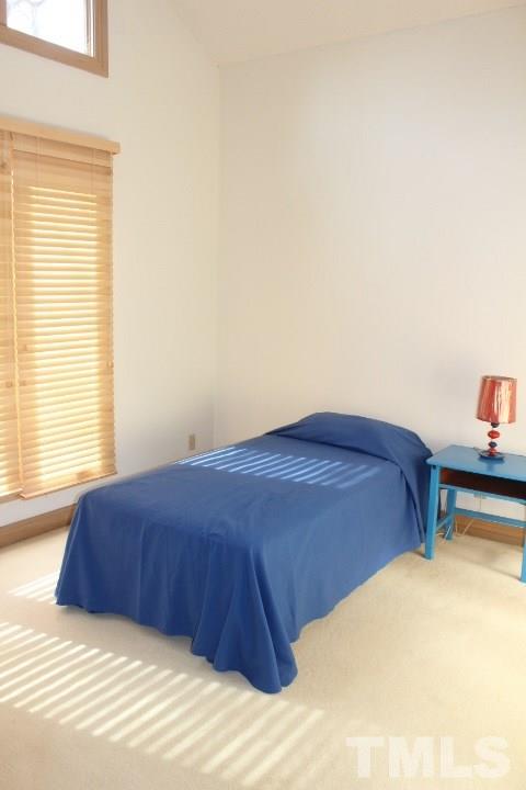 10700 Dunhill Terrace Raleigh, NC 27615 - Photo 12 of 16 a bedroom with a bed and a window