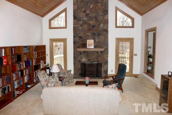10700 Dunhill Terrace Raleigh, NC 27615 - Photo 4 of 16 a living room with furniture a fireplace and a book shelf