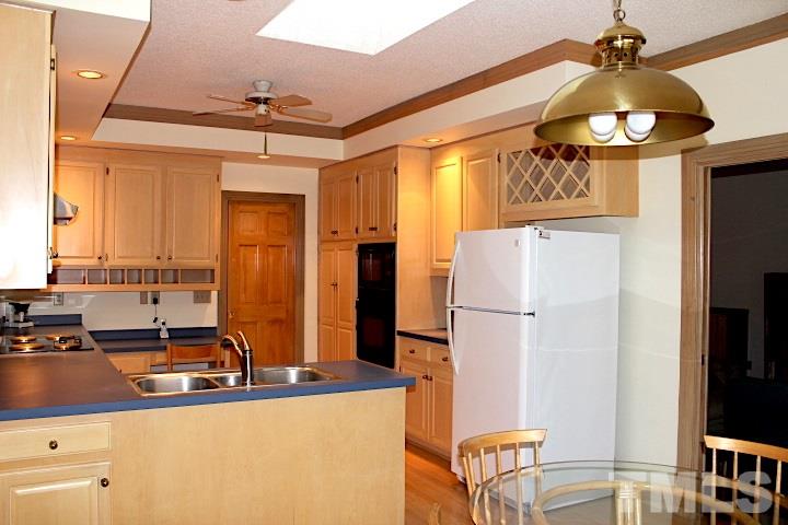 10700 Dunhill Terrace Raleigh, NC 27615 - Photo 7 of 16 a kitchen with stainless steel appliances granite countertop a sink a refrigerator and a stove