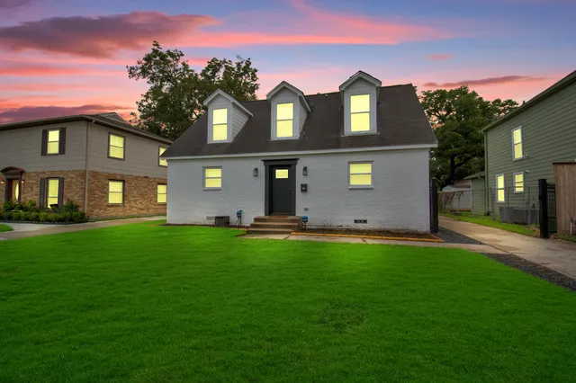 a front view of a house with a garden