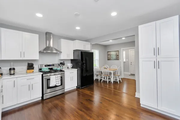 a kitchen with white cabinets and stainless steel appliances