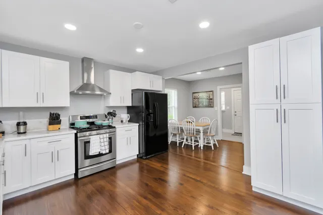 a kitchen with white cabinets and stainless steel appliances