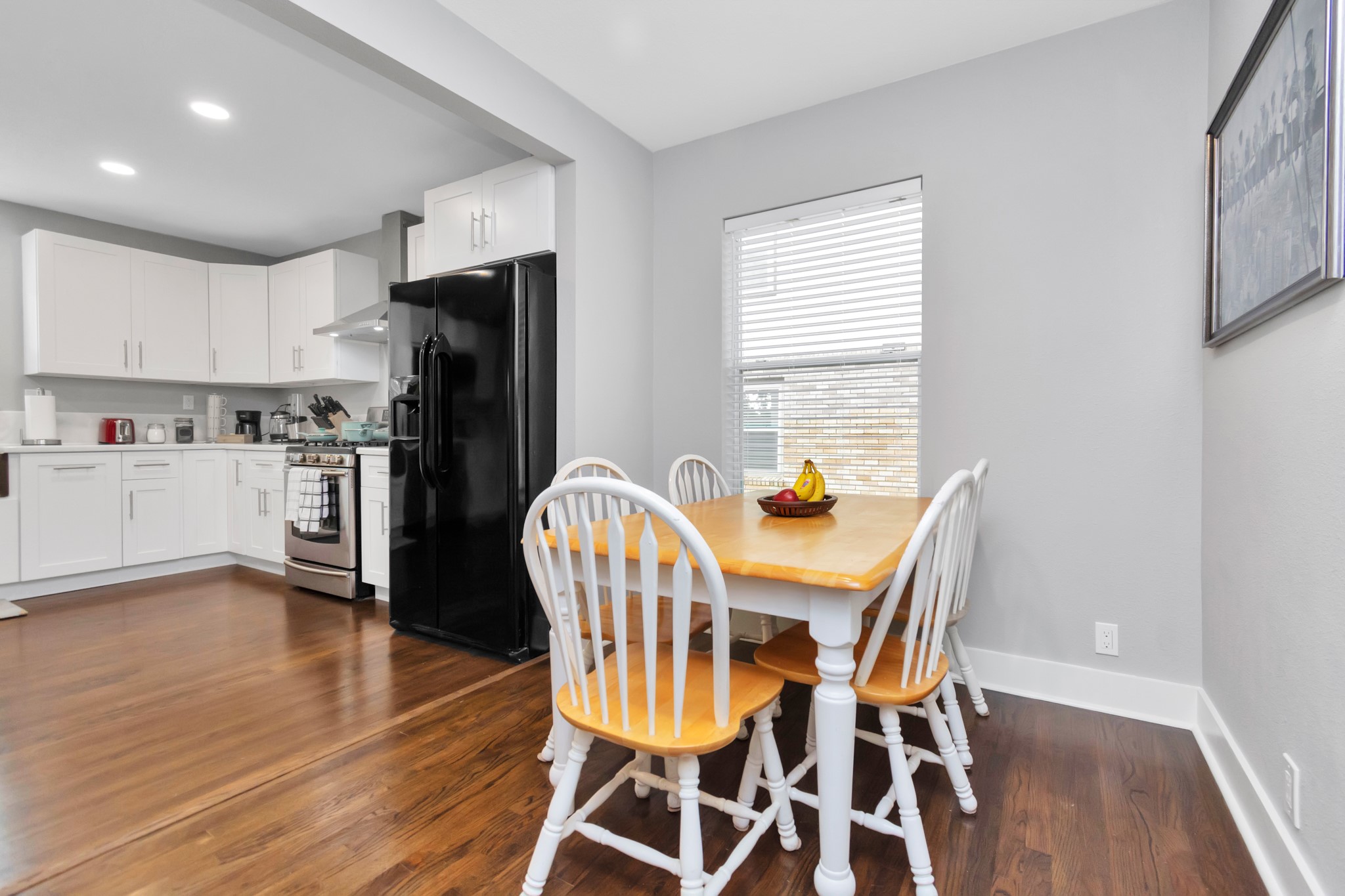 3315 Rosedale Street Houston, TX 77004 - Photo 12 of 32 a view of a dining room with furniture and wooden floor