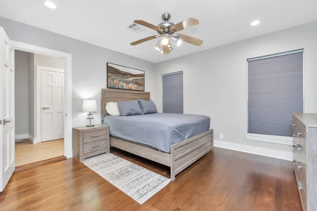 a bedroom with a large bed and a chandelier