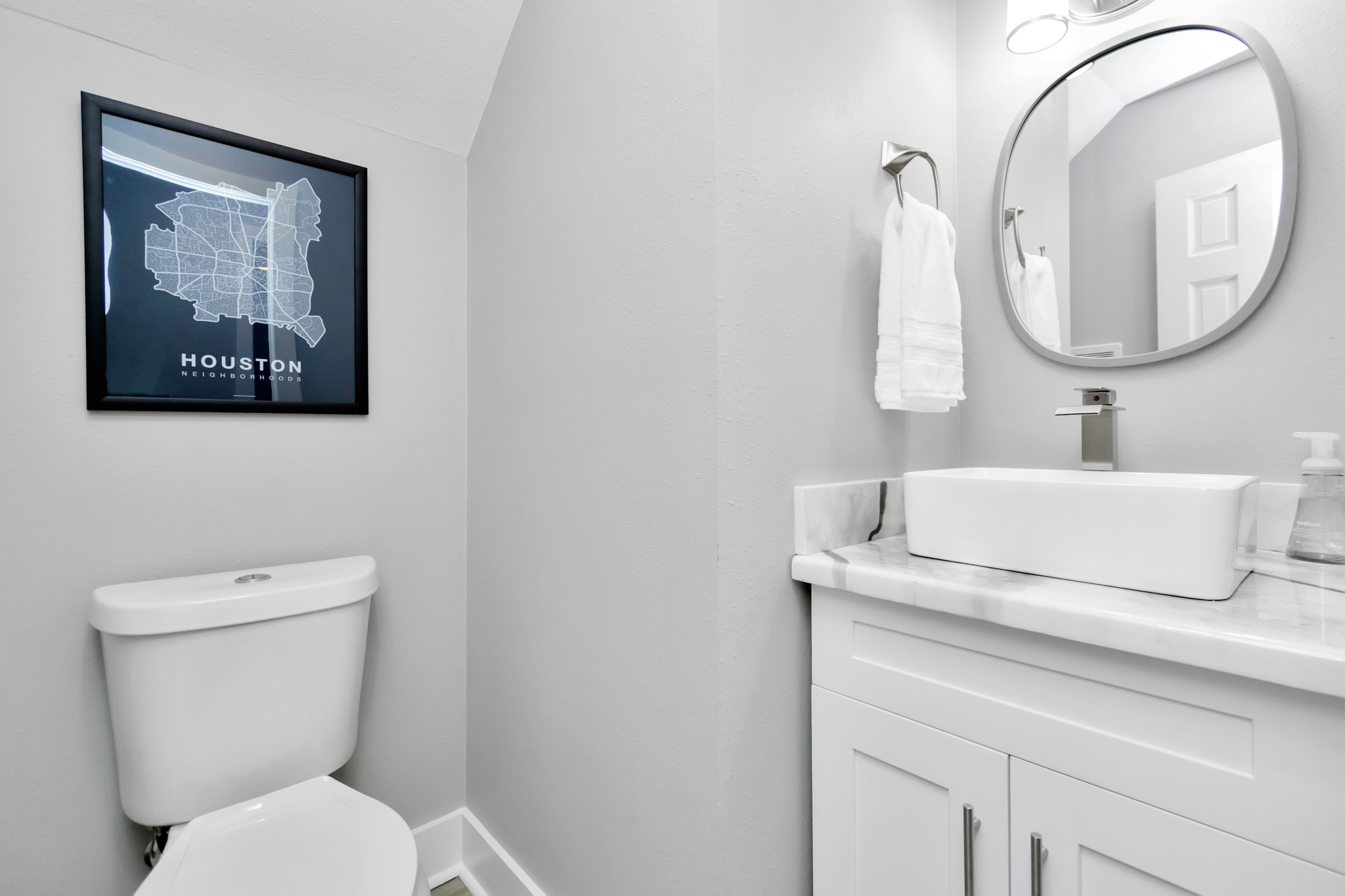 3315 Rosedale Street Houston, TX 77004 - Photo 19 of 32 a bathroom with a toilet a sink and a mirror