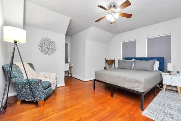 a bedroom with a bed and lamp with potted plant
