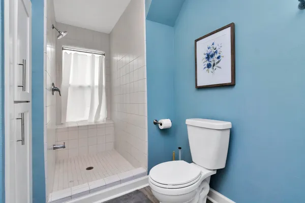 a white toilet sitting next to a bathroom sink