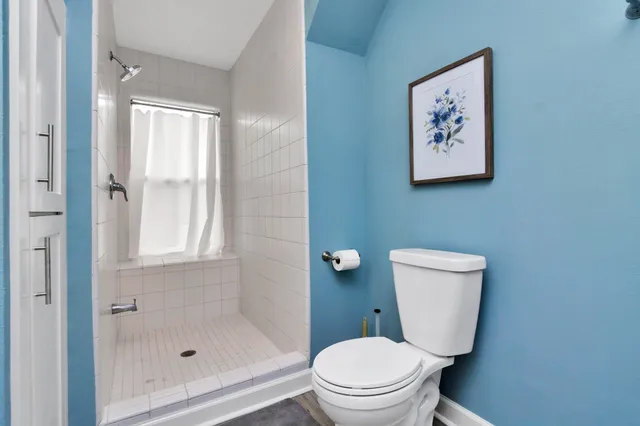 a white toilet sitting next to a bathroom sink
