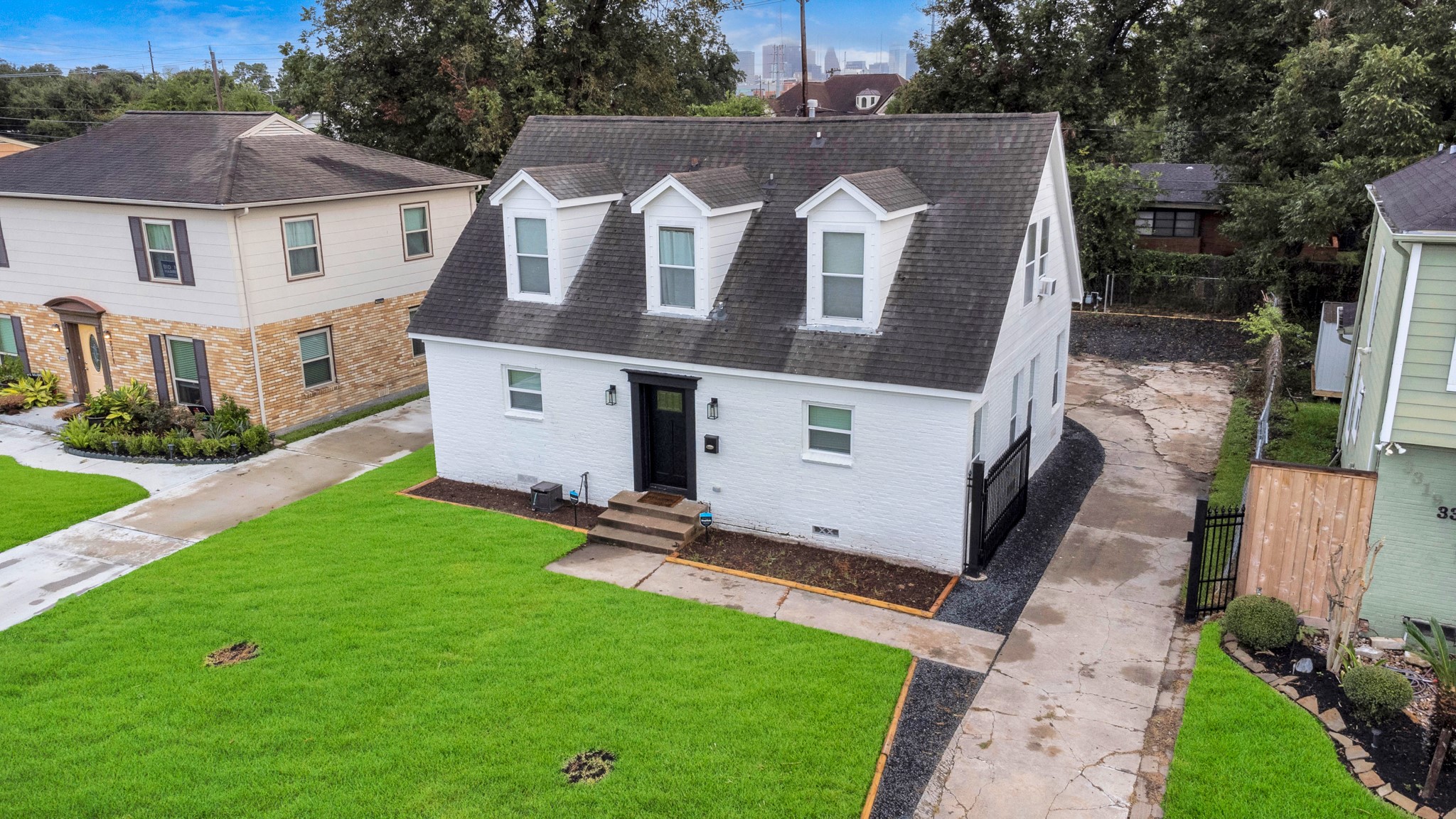 3315 Rosedale Street Houston, TX 77004 - Photo 31 of 32 a view of a white house next to a yard with big trees