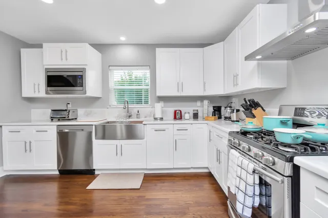 a kitchen with a stove a sink and a microwave