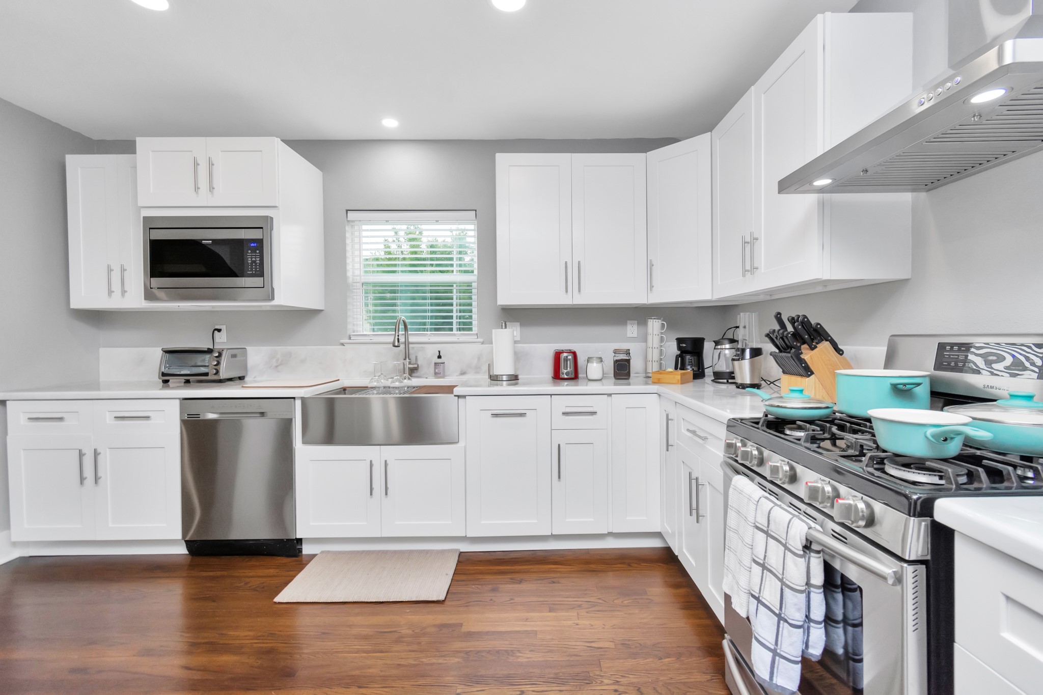 3315 Rosedale Street Houston, TX 77004 - Photo 10 of 32 a kitchen with a stove a sink and a microwave
