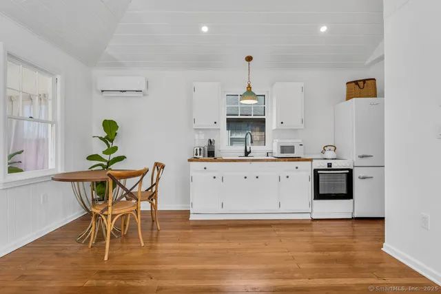 a view of a kitchen with a table and chairs in it