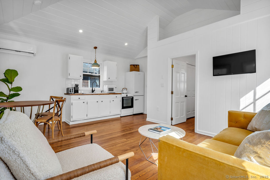 69 Waterside Lane, Unit 3 Clinton, CT 06413 - Photo 15 of 18 a living room with furniture and a flat screen tv