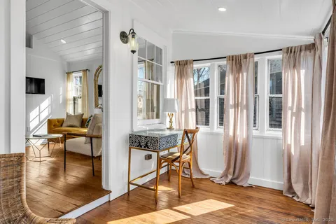 a view of a livingroom with furniture and a window