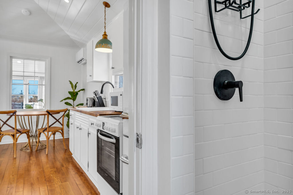 69 Waterside Lane, Unit 3 Clinton, CT 06413 - Photo 2 of 18 a bathroom with a sink a mirror and a shower