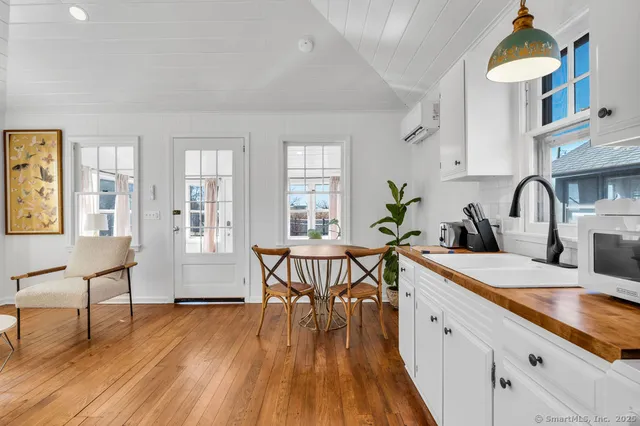 a very nice looking living room with a sink and a large window