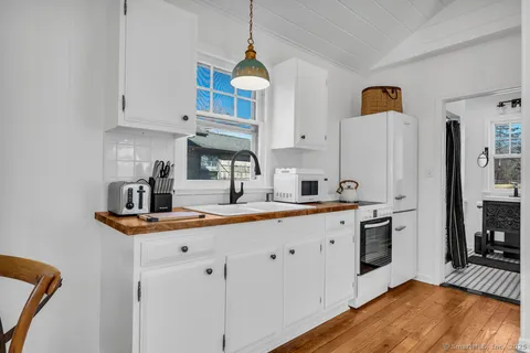 a kitchen with stainless steel appliances a sink a stove a refrigerator and cabinets