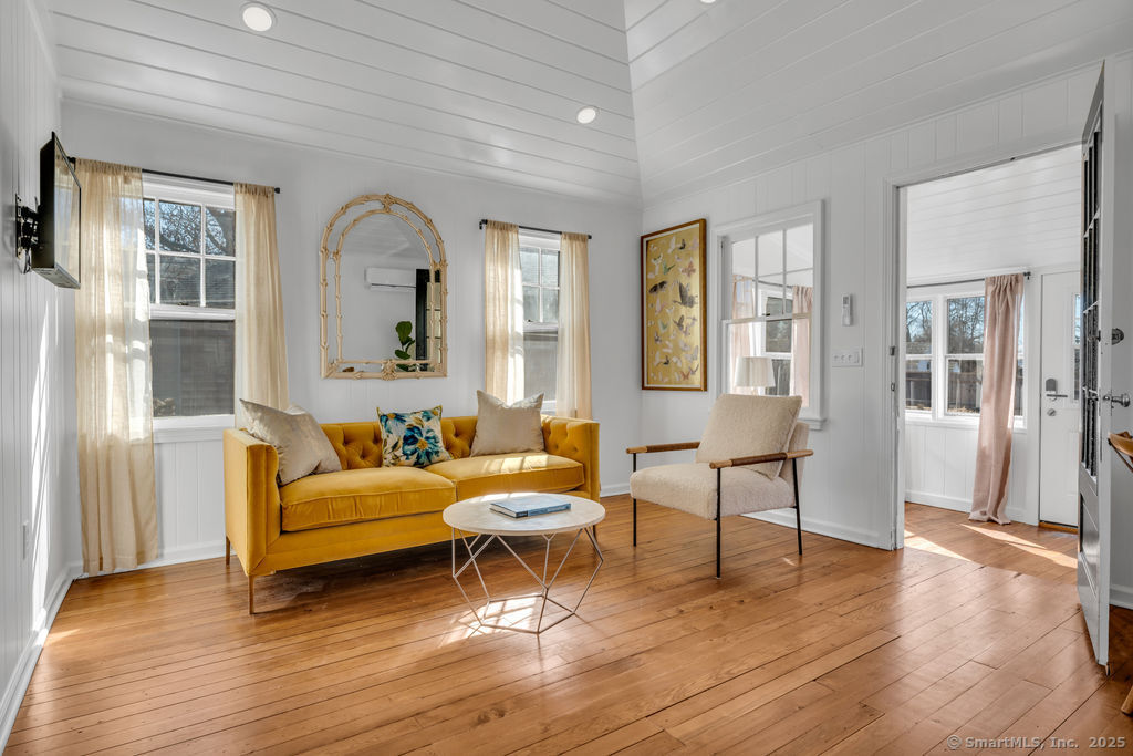 69 Waterside Lane, Unit 3 Clinton, CT 06413 - Photo 10 of 18 a living room with furniture and a wooden floor