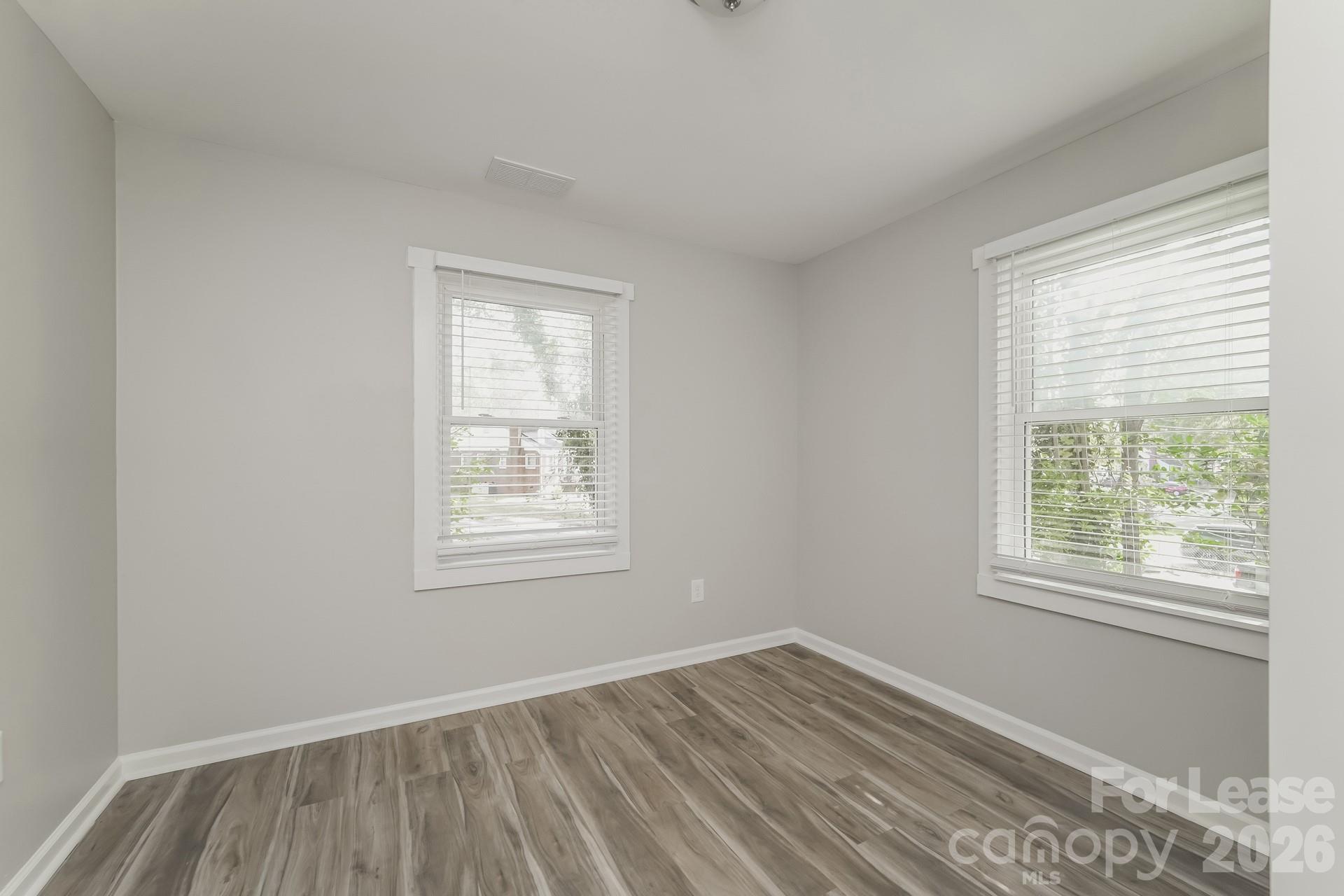2824 Beech Nut Road Charlotte, NC 28208 - Photo 11 of 16 a view of an empty room with wooden floor and a window