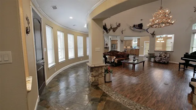 a living room with furniture and a chandelier
