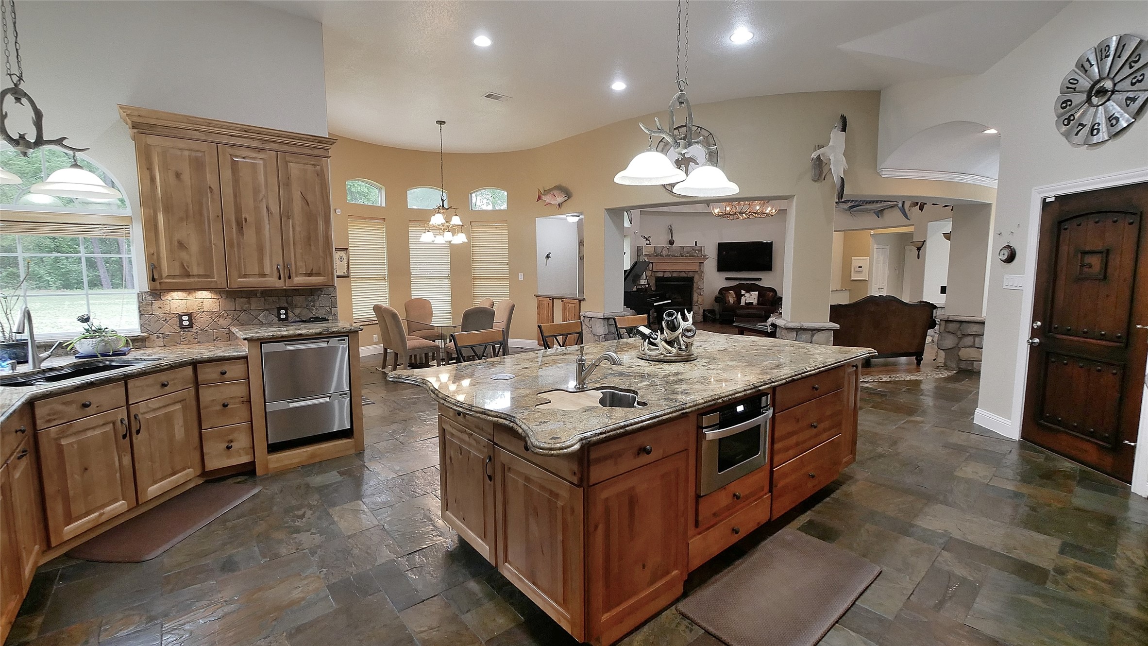 23478 Bays Chapel Road Richards, TX 77873 - Photo 17 of 49 a kitchen with stainless steel appliances granite countertop a stove a sink dishwasher a refrigerator and a dining table with wooden floor