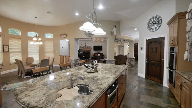 a large kitchen with a table and chairs