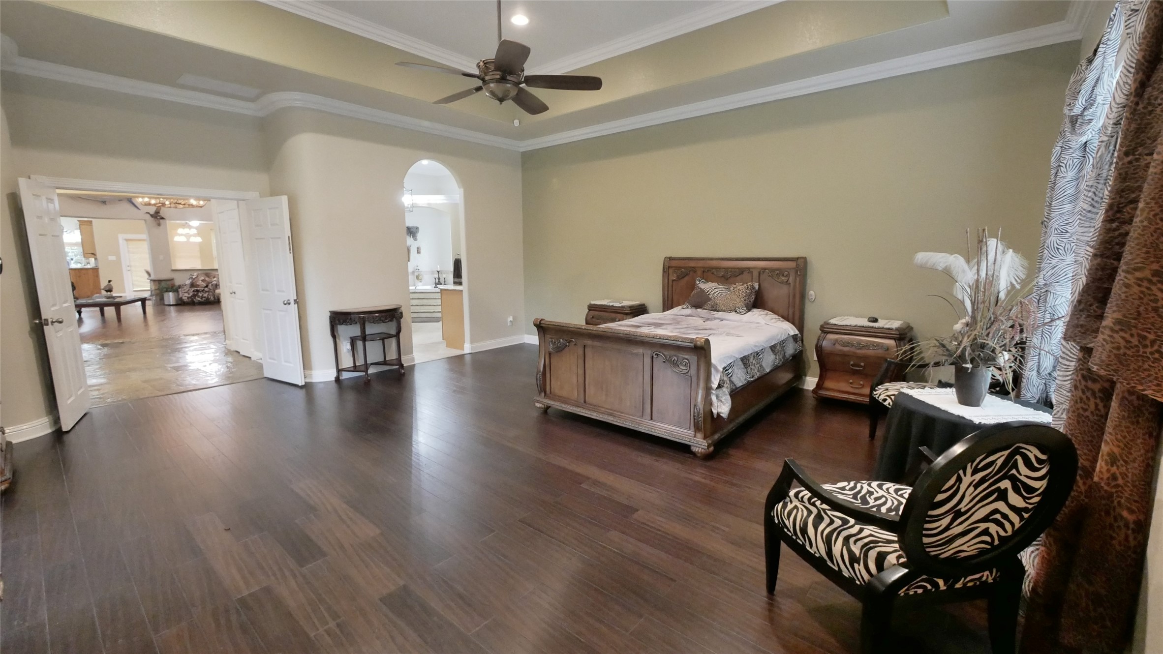 23478 Bays Chapel Road Richards, TX 77873 - Photo 22 of 49 a spacious bedroom with a bed a couch and a chandelier