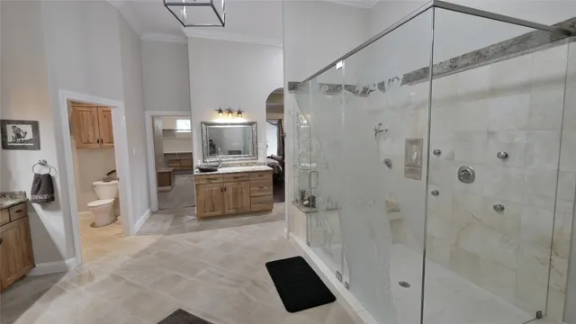 a bathroom with a shower a sink and a mirror