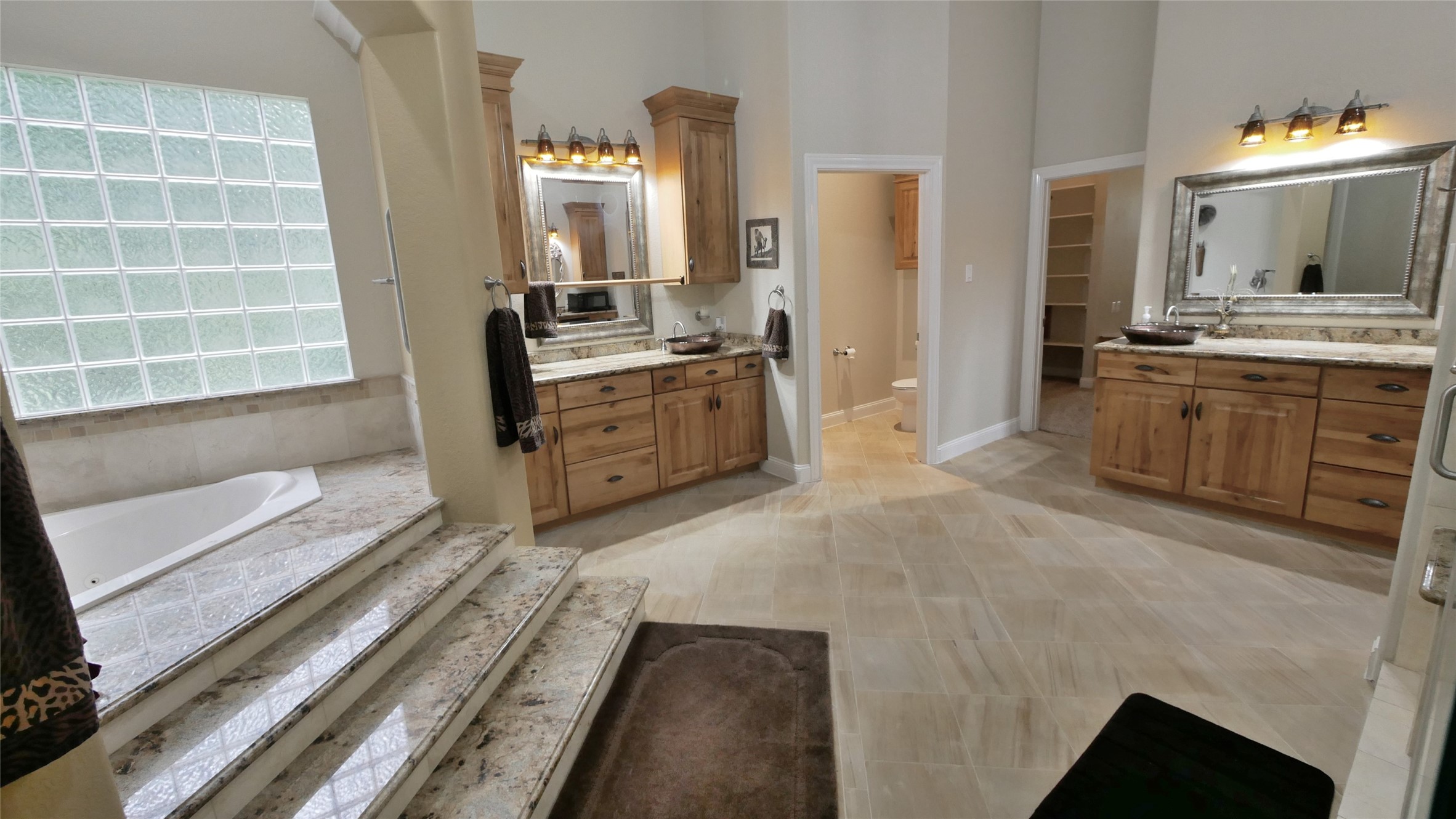 23478 Bays Chapel Road Richards, TX 77873 - Photo 25 of 49 a spacious bathroom with a double vanity sink a mirror and a bathtub
