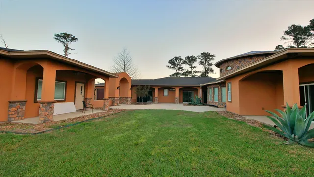 a view of a house with a yard porch and sitting area