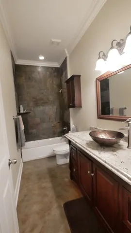 a bathroom with a granite countertop sink a toilet and bathtub
