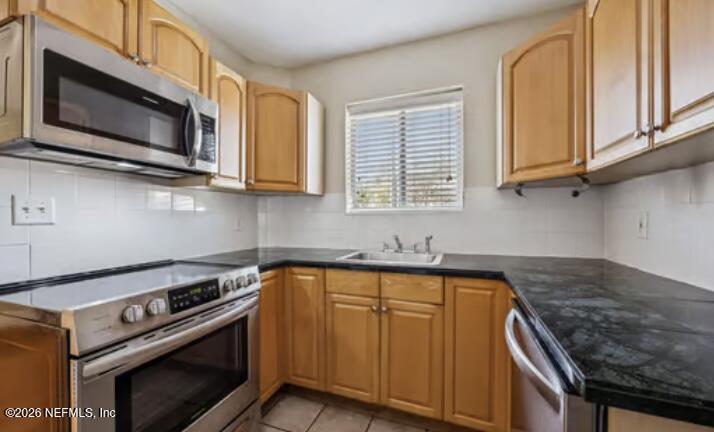 2159 Riverside Avenue, Unit 7 Jacksonville, FL 32204 - Photo 13 of 29 a kitchen with stainless steel appliances granite countertop a stove microwave and sink