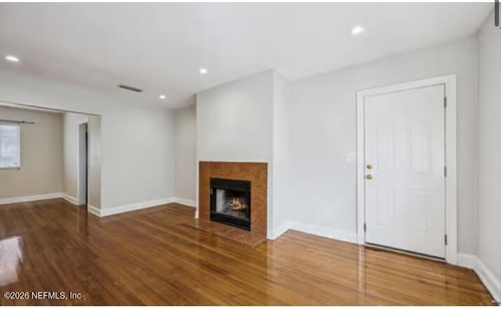 2159 Riverside Avenue, Unit 7 Jacksonville, FL 32204 - Photo 7 of 29 a view of an empty room with wooden floor fireplace and a window