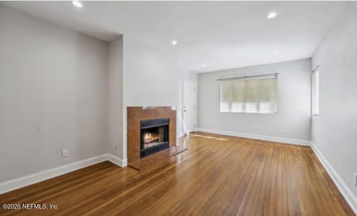 2159 Riverside Avenue, Unit 7 Jacksonville, FL 32204 - Photo 8 of 29 a view of empty room with wooden floor and fireplace