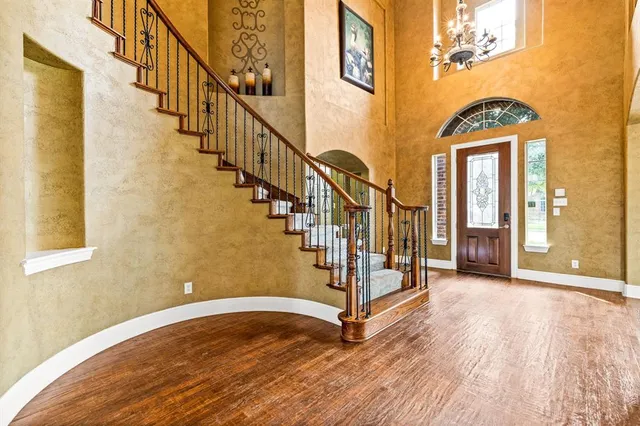 a view of entryway with wooden floor and stairs