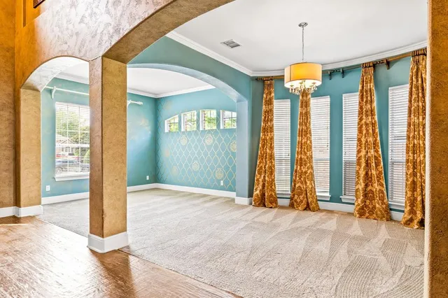 a view of empty room with floor to ceiling window and ceiling fan
