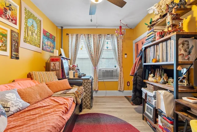 a bedroom with furniture and a book shelf