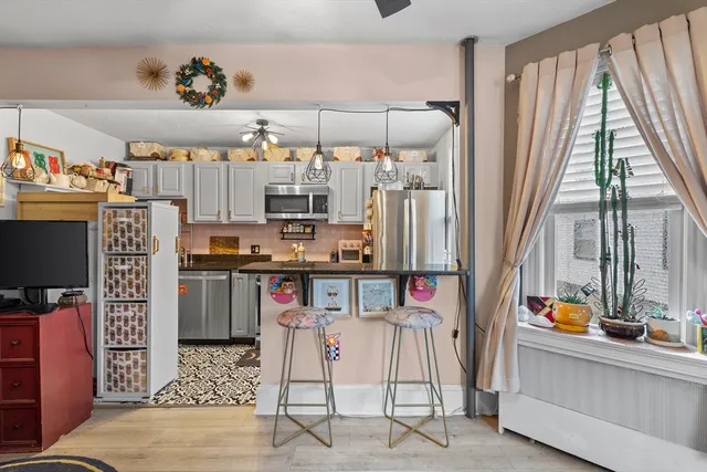 a kitchen with stainless steel appliances kitchen island granite countertop a refrigerator and a stove