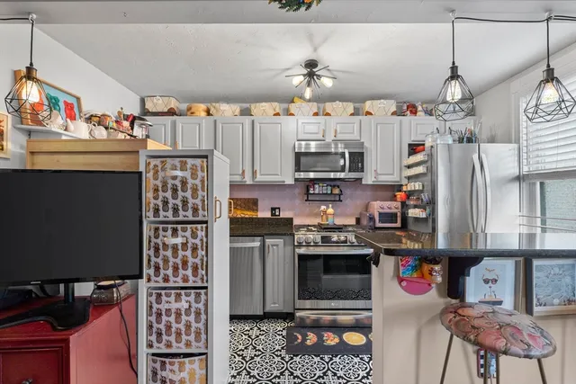 a kitchen with stainless steel appliances a stove a refrigerator and cabinets